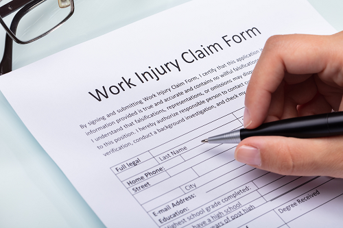 A workers injury claim form being filled out.