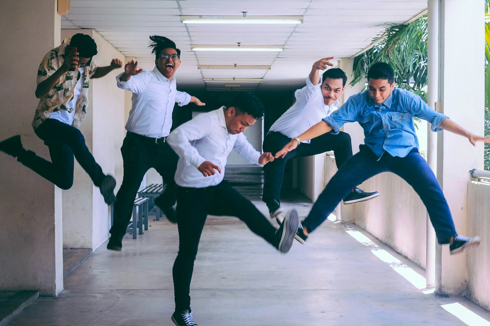 group of people doing jump shot photography because they're happy with employee assistance programs